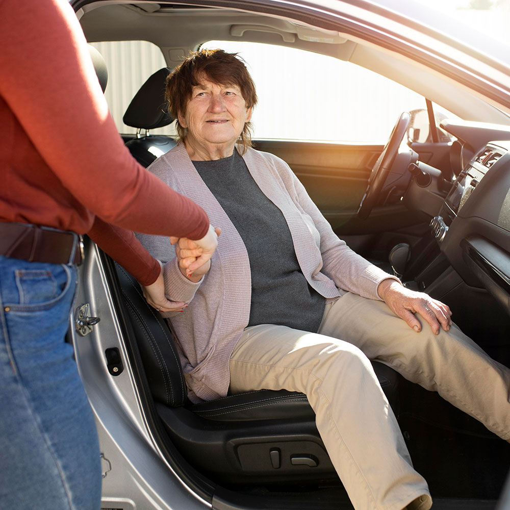 Elderly woman being transported by an NEMT driver in Texas